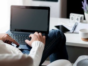 Man working on laptop in living room